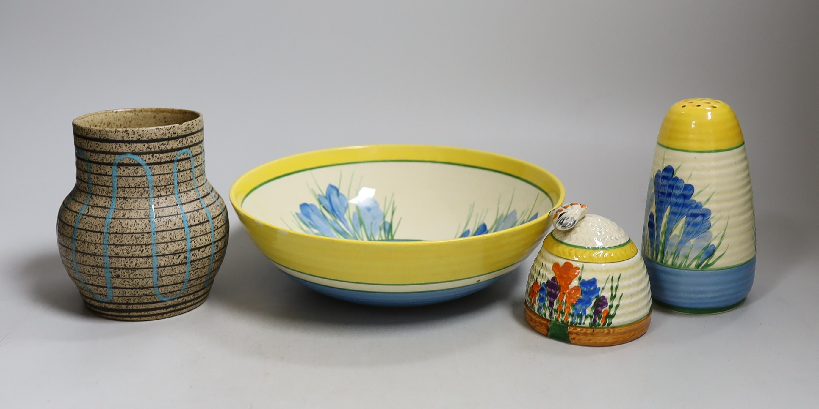 A Clarice Cliff blue crocus caster and bowl, a Clarice Cliff crocus honey pot and a late brown glazed vase. Tallest 18cm